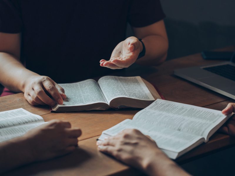 Christian Bible Study Concepts. Christian friend's groups read and study the bible together in a home with window light. followers are studying the word of God in churches.